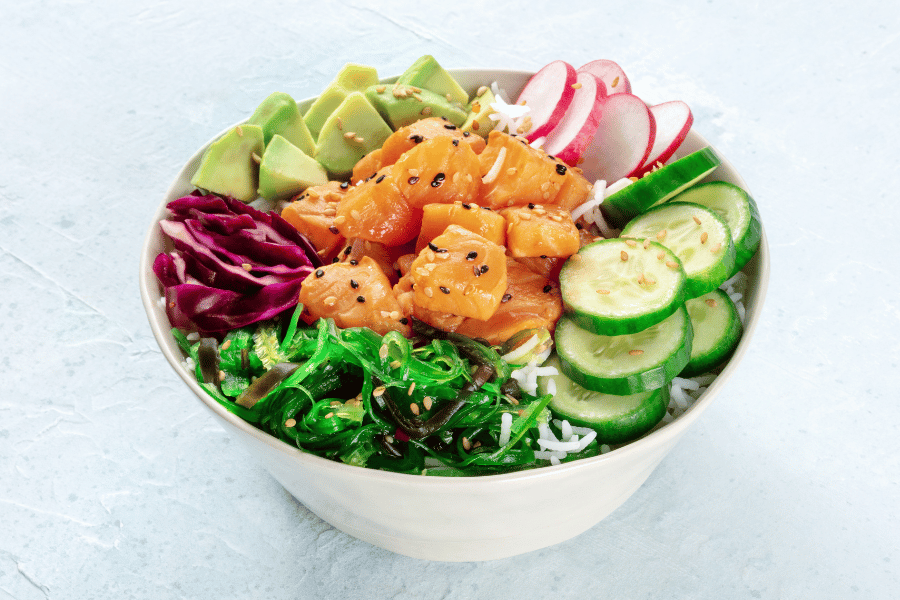 photo of a bowl of salmon and vegetables including avocado