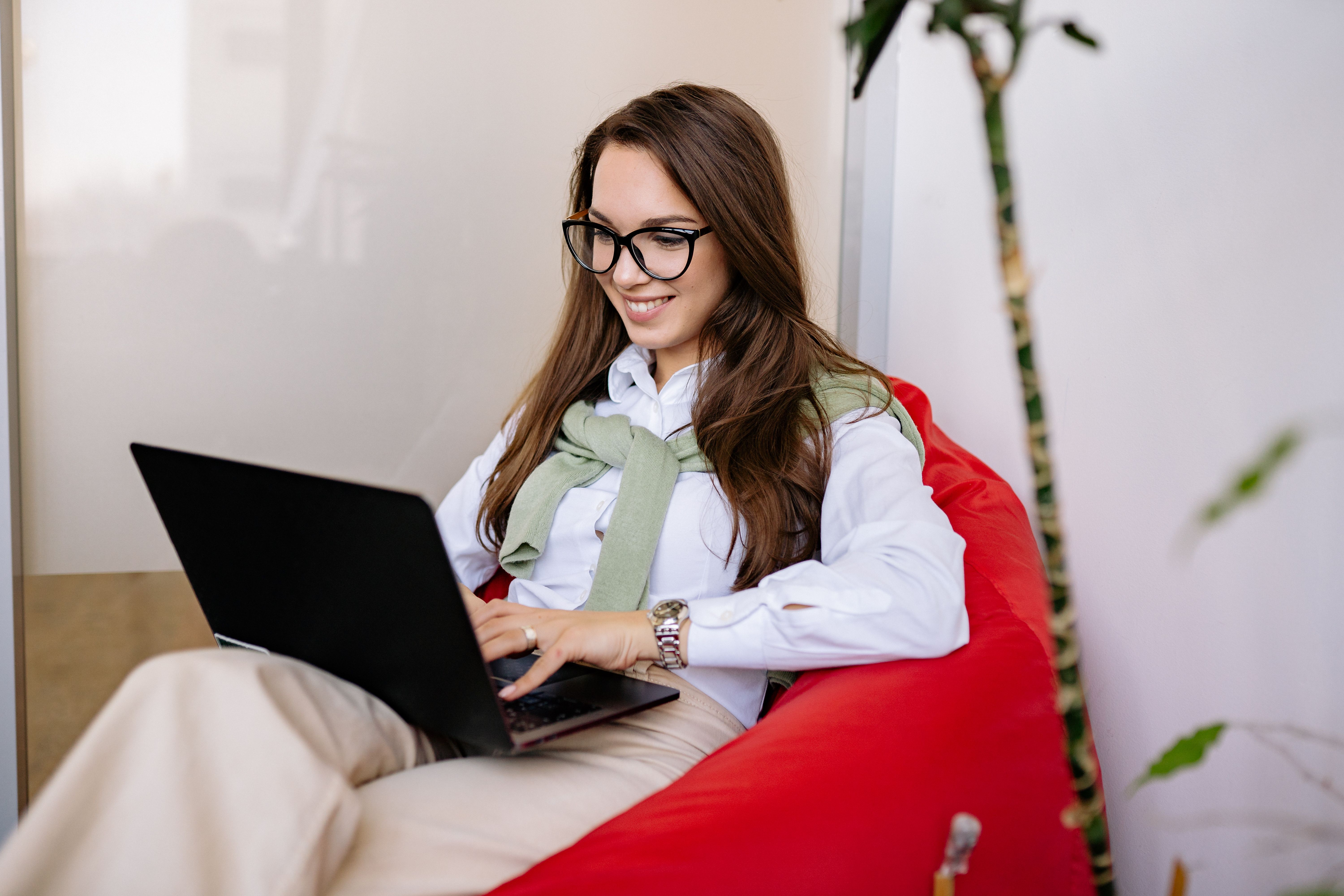 Founder relaxing with laptop closed — working fewer hours and earning more through smart business systems