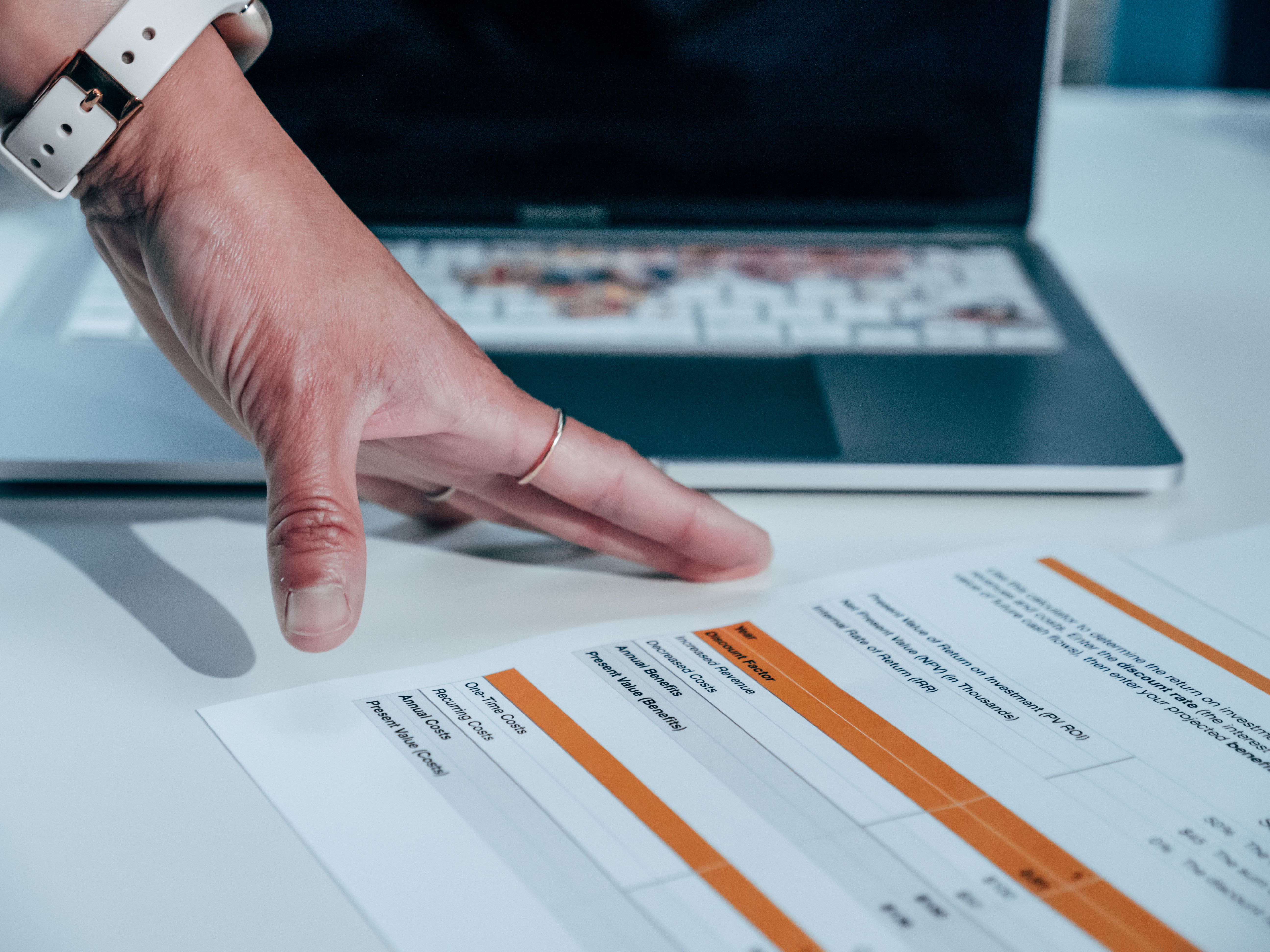 Founder reviewing pricing strategy on laptop — how to price offers correctly without undercharging