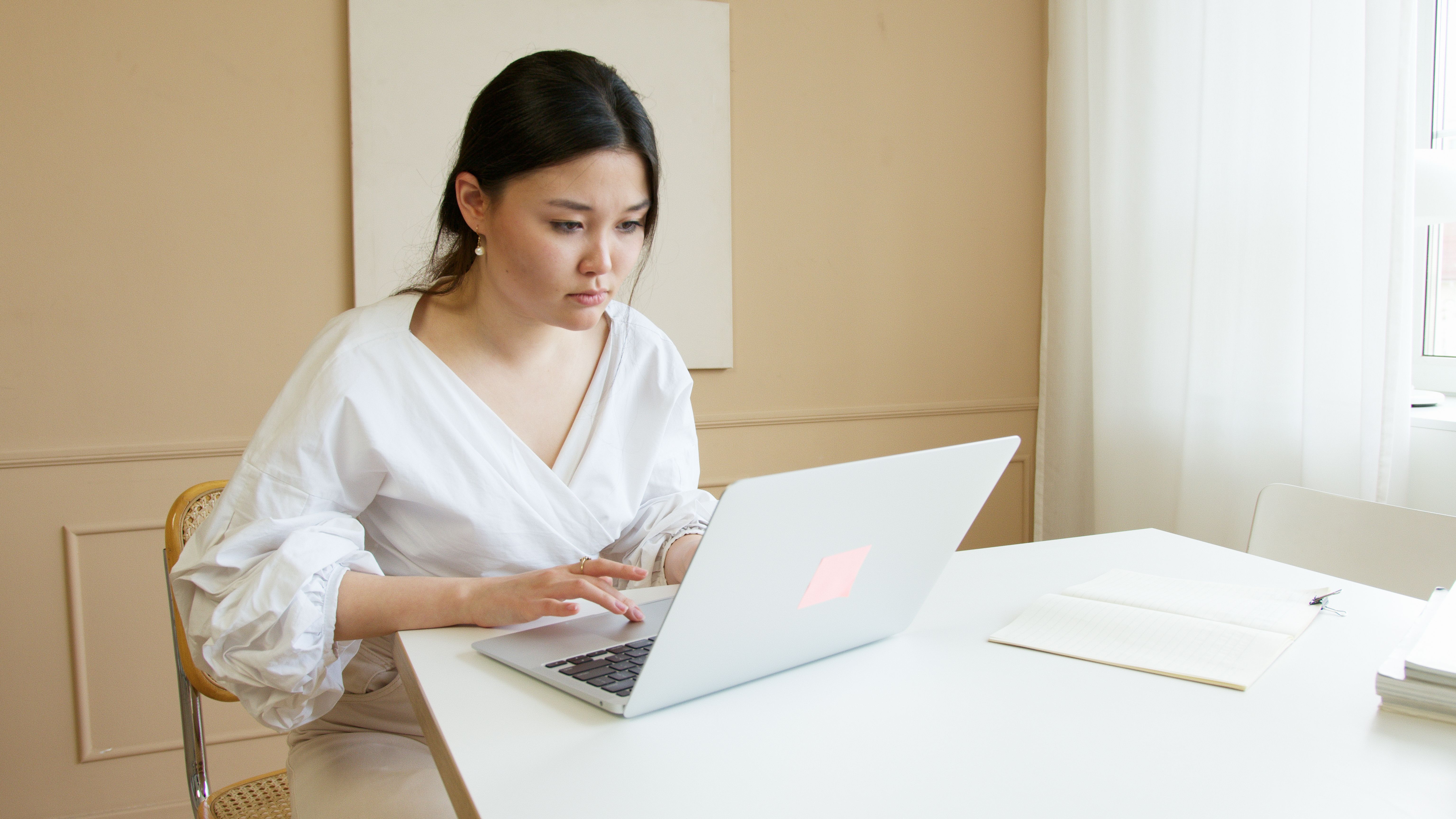 Founder sitting calmly working from laptop — running a sustainable business without burnout