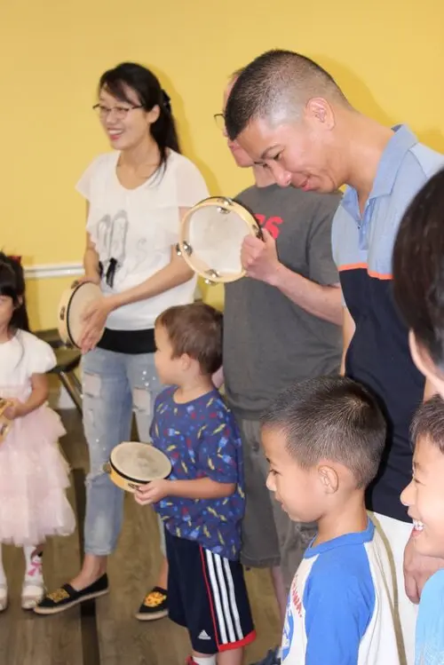 Children and parents making music together at Olenka School of Music