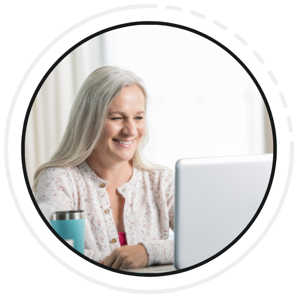 Smiling woman looking at laptop on a virtual call