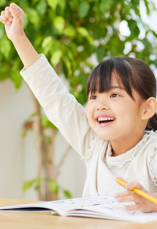 Smiling girl raising hand asking a question