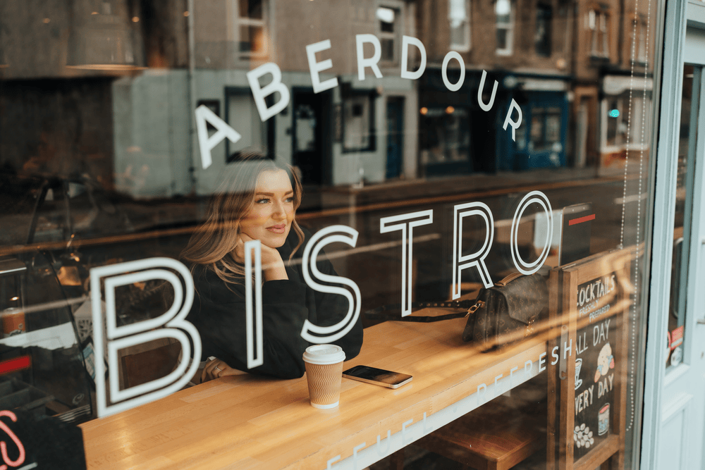 the roadblock coach sitting in front of a window thinking.