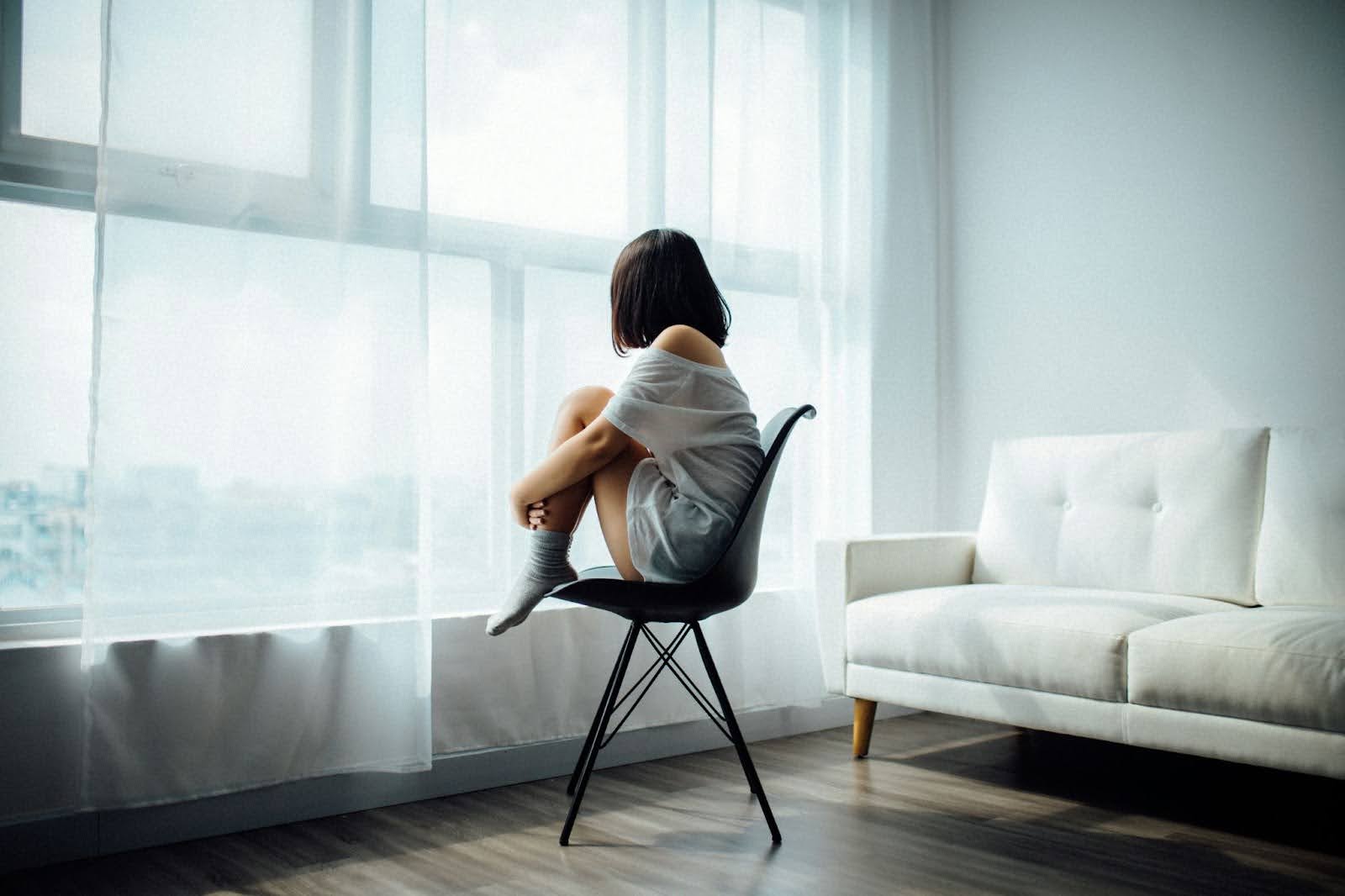 Girl in chair by window: Contemplation, recognizing manipulation