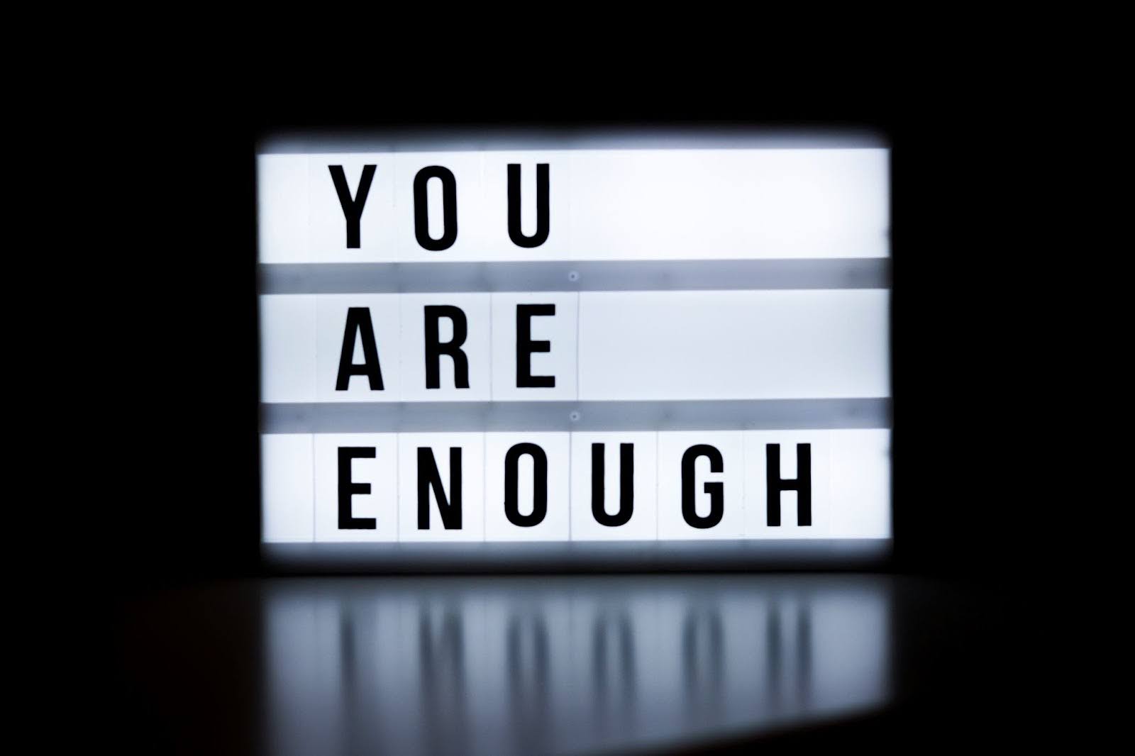 Words 'you are enough,' symbolizing self-compassion and self-worth.