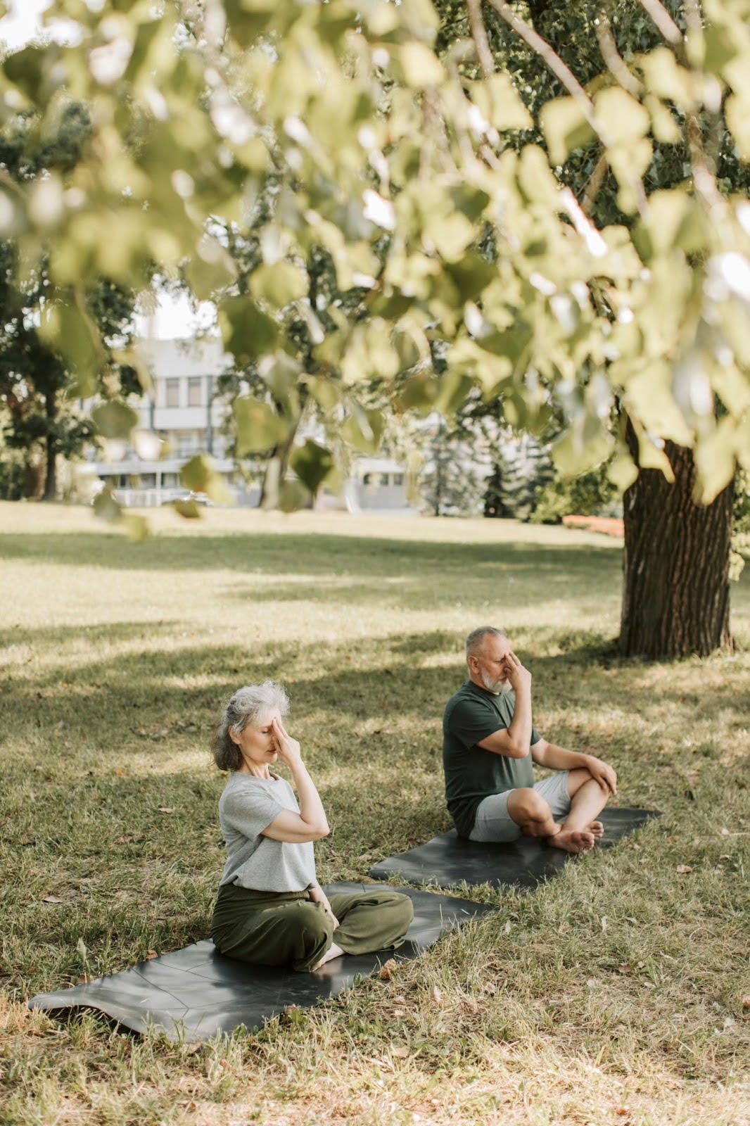 Man and woman in the park, showing meditation and mindfulness techniques