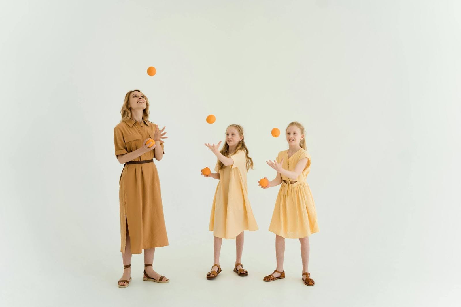 Woman and kids juggling with balls, illustrating various roles and responsibilities