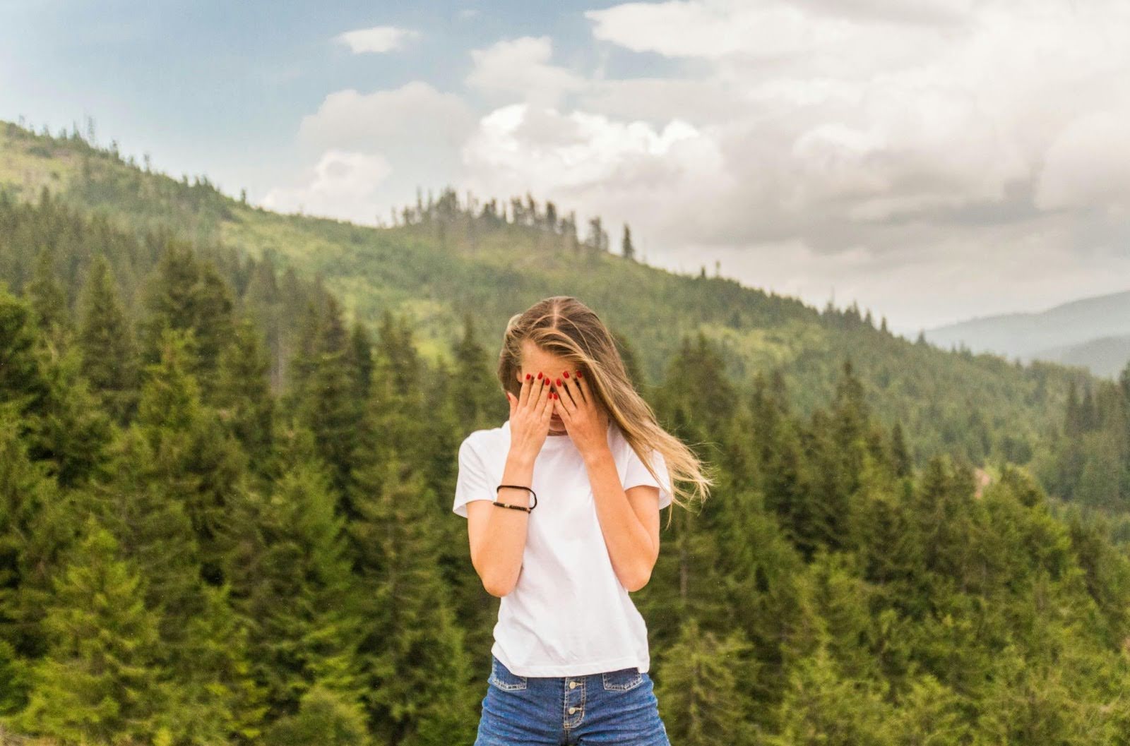 Girl with head down, hands covering eyes, symbolizing the struggle with shame and negative self-beliefs.