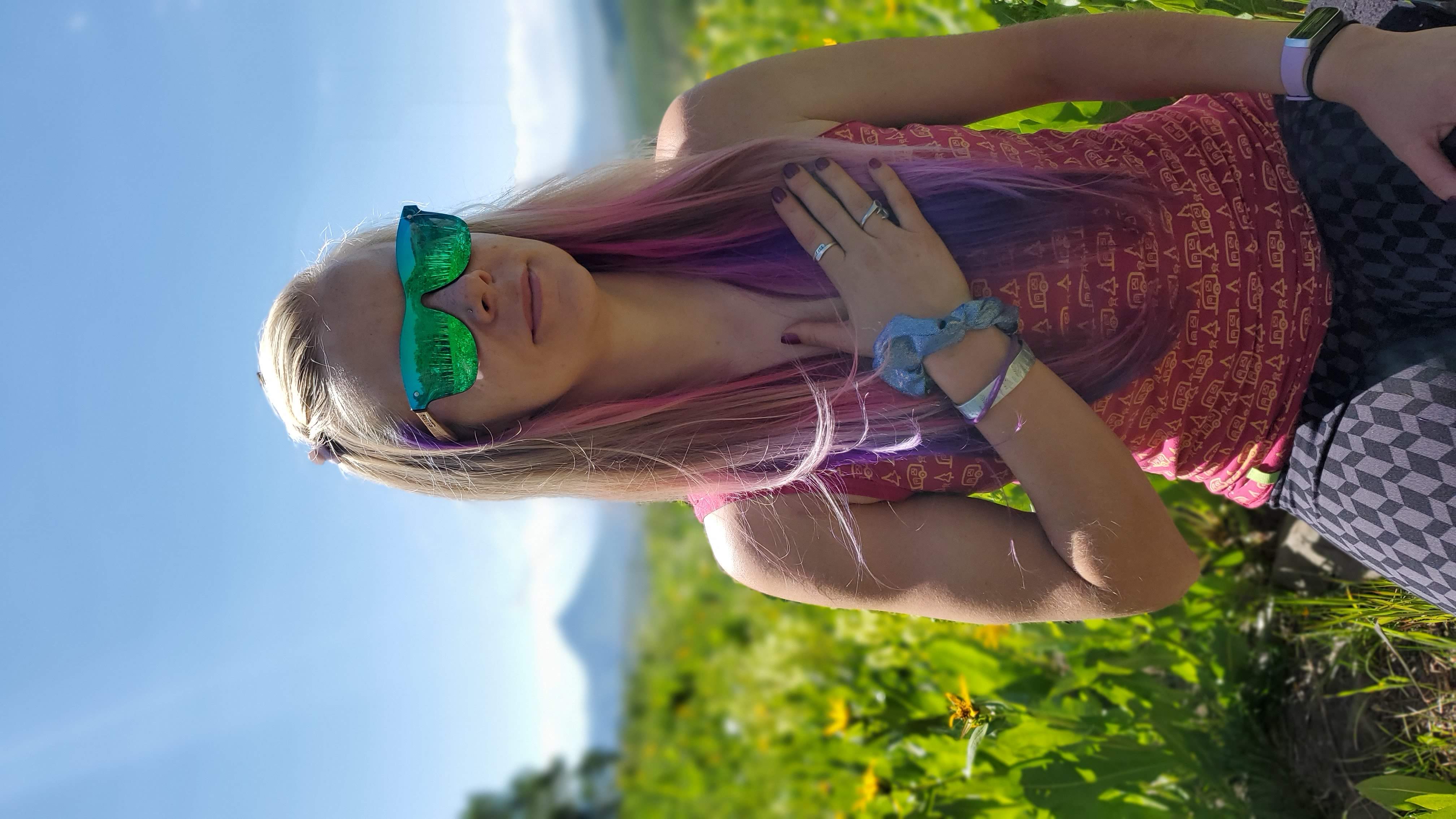 Dr. Saara with hand on chest in nature