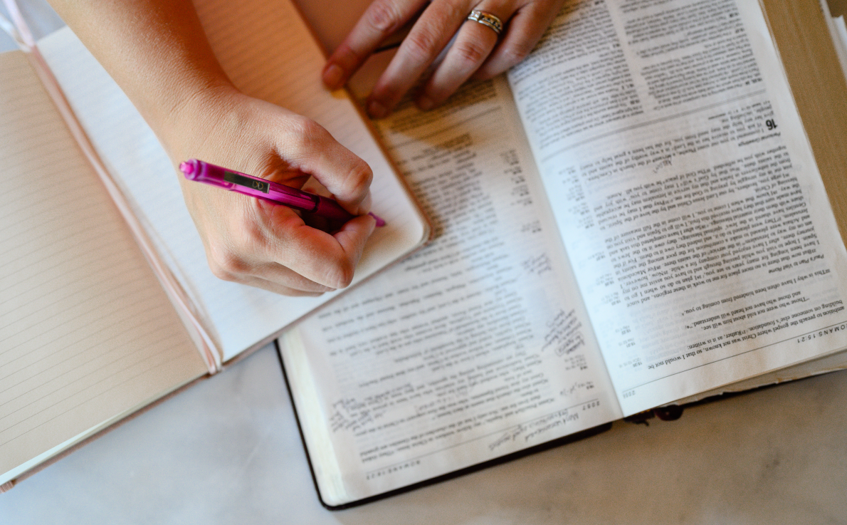 Notebook and Bible open with pen, symbolizing strategic and spiritual planning