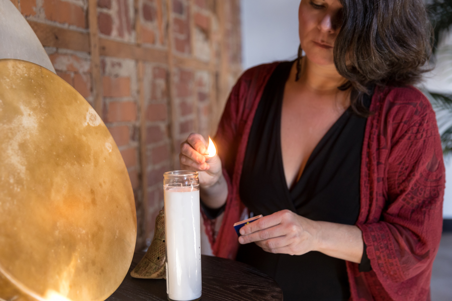 Brighid Murphy lighting a candle