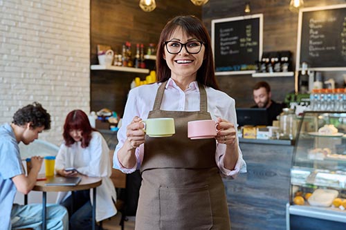 Smiling female coffee shop owner