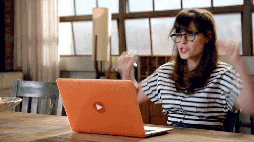 "Happy woman gesturing at laptop screen