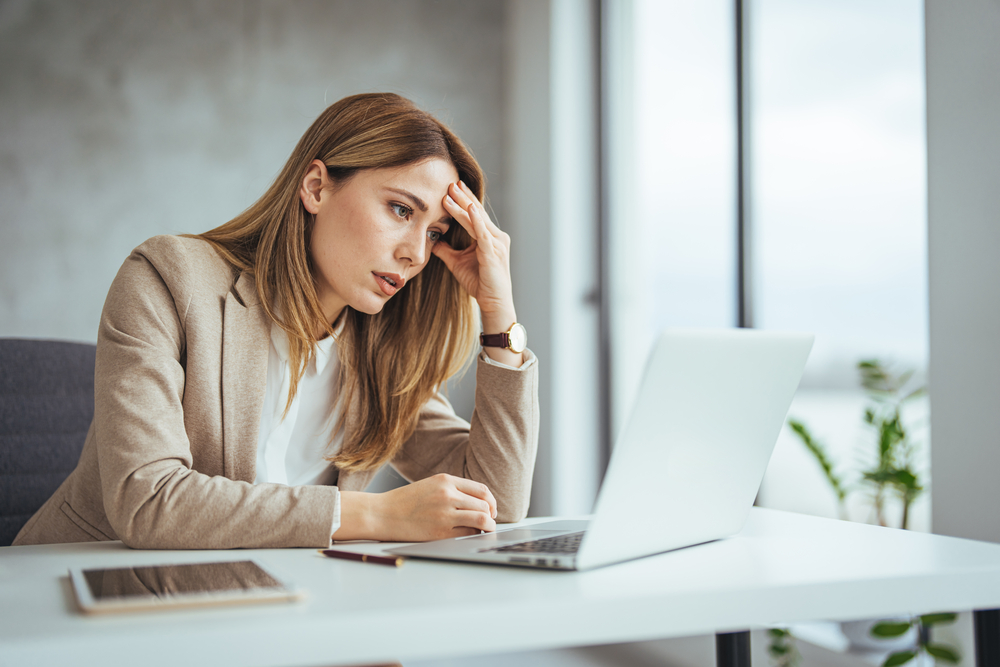 Stressed businesswoman at laptop in office