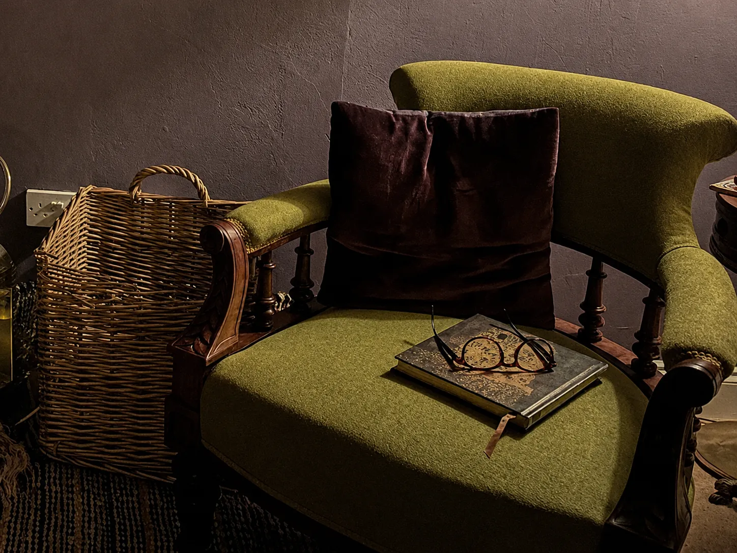 A quiet reading corner in the guest lounge, with an armchair and a lamp