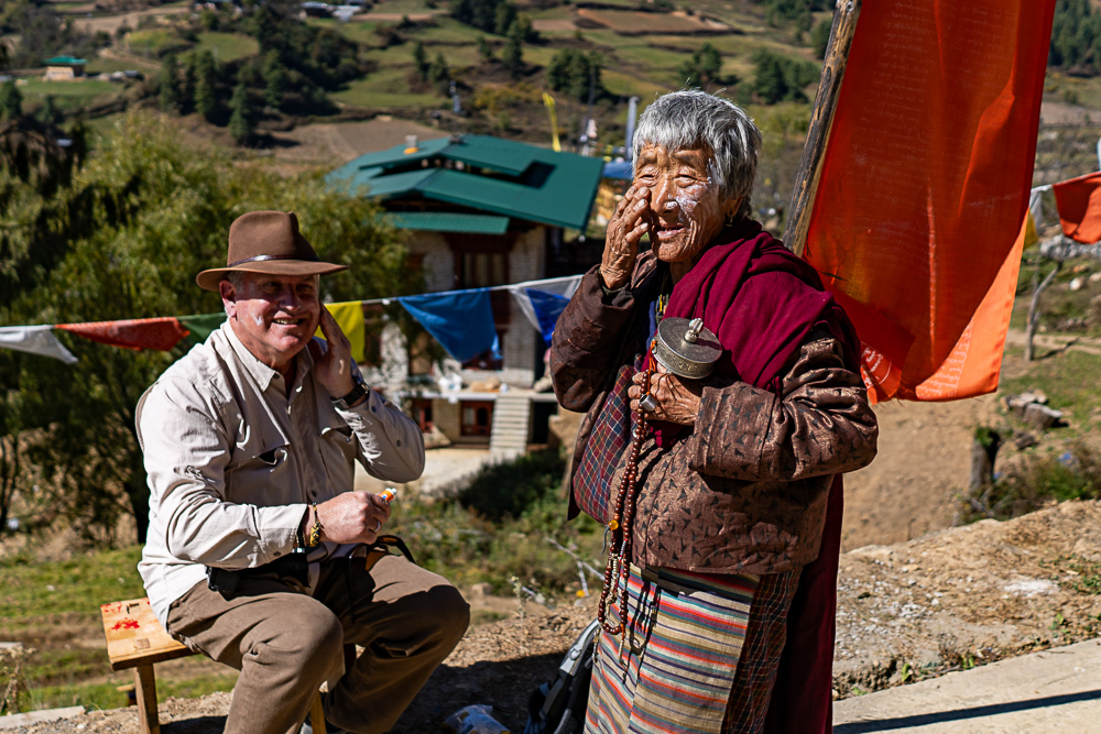 Horses grazing in a wide valley landscape in Bhutan - Raw Tours photo tour scenery.