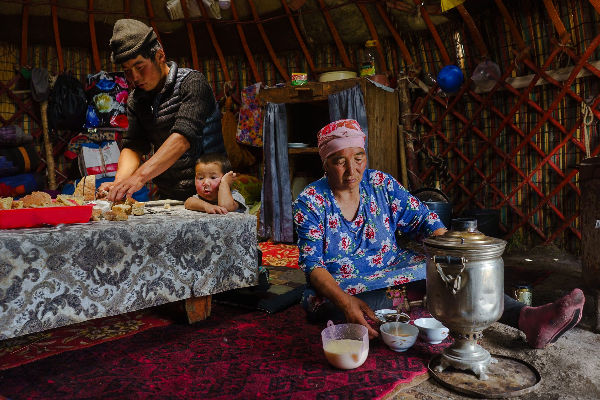 Inside a Kyrgyz yurt showing traditional tea preparation - highlights from a Raw Tours journey