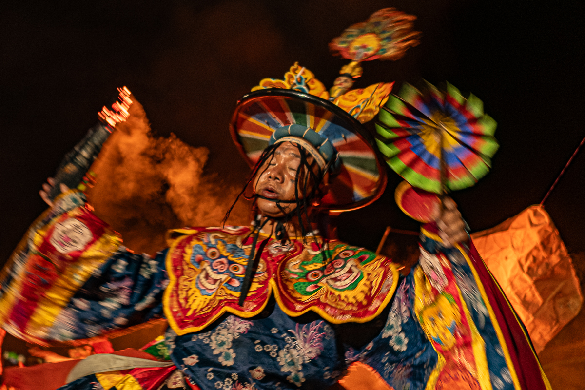 Bhutanese festival dancer spinning in colorful traditional costume - a destination offered by Raw Tours