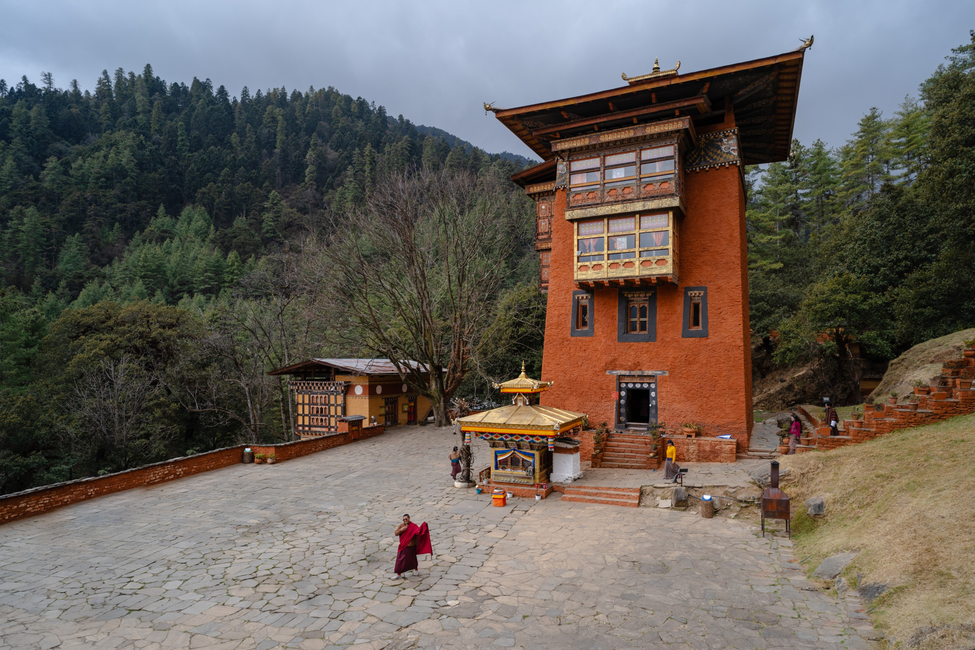 Architectural view of traditional Bhutanese Dzong fortress in a valley - Raw Tours destination.