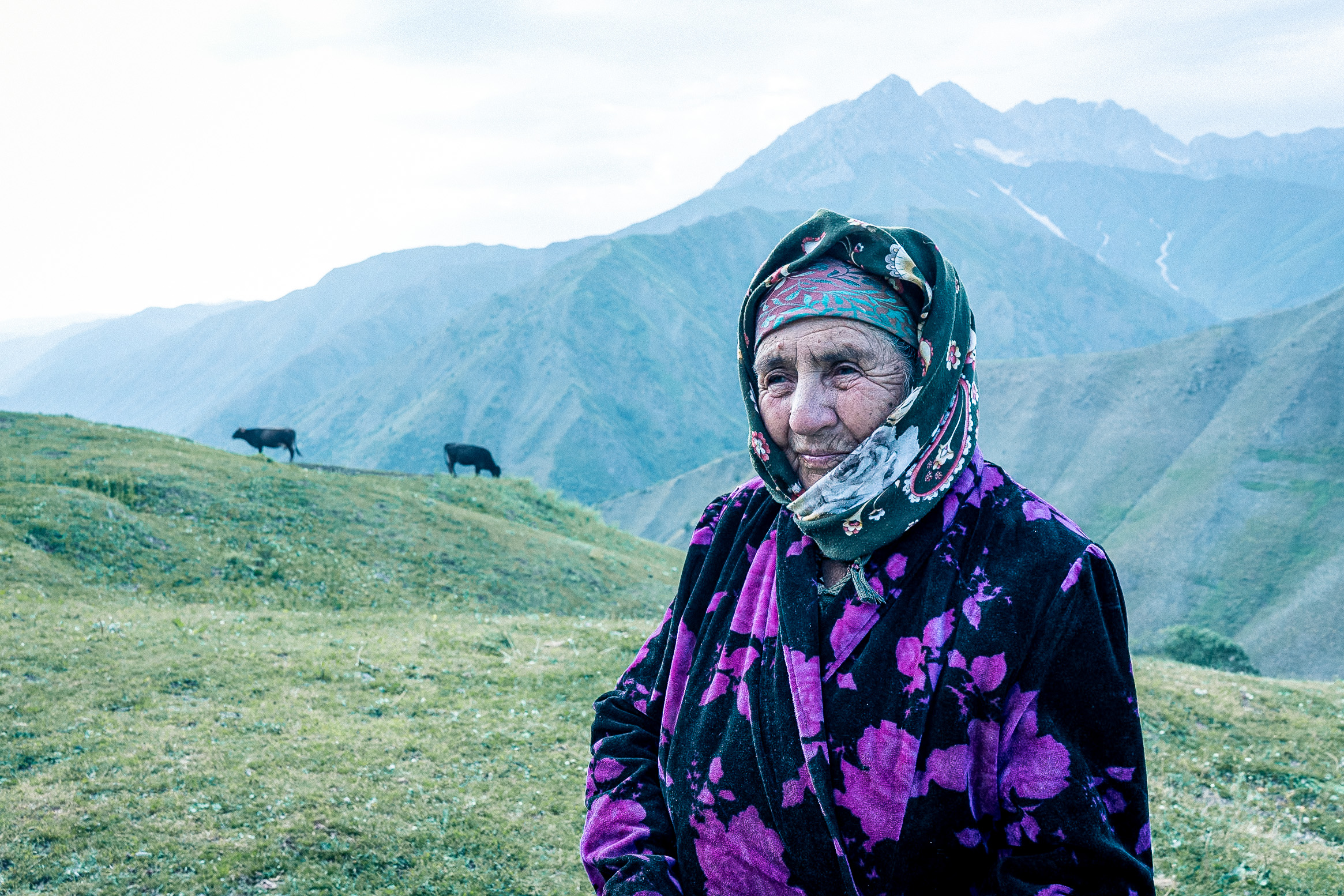 Kyrgyz woman in mountainous landscape - portrait from Raw Tours Kyrgyzstan photo tour
