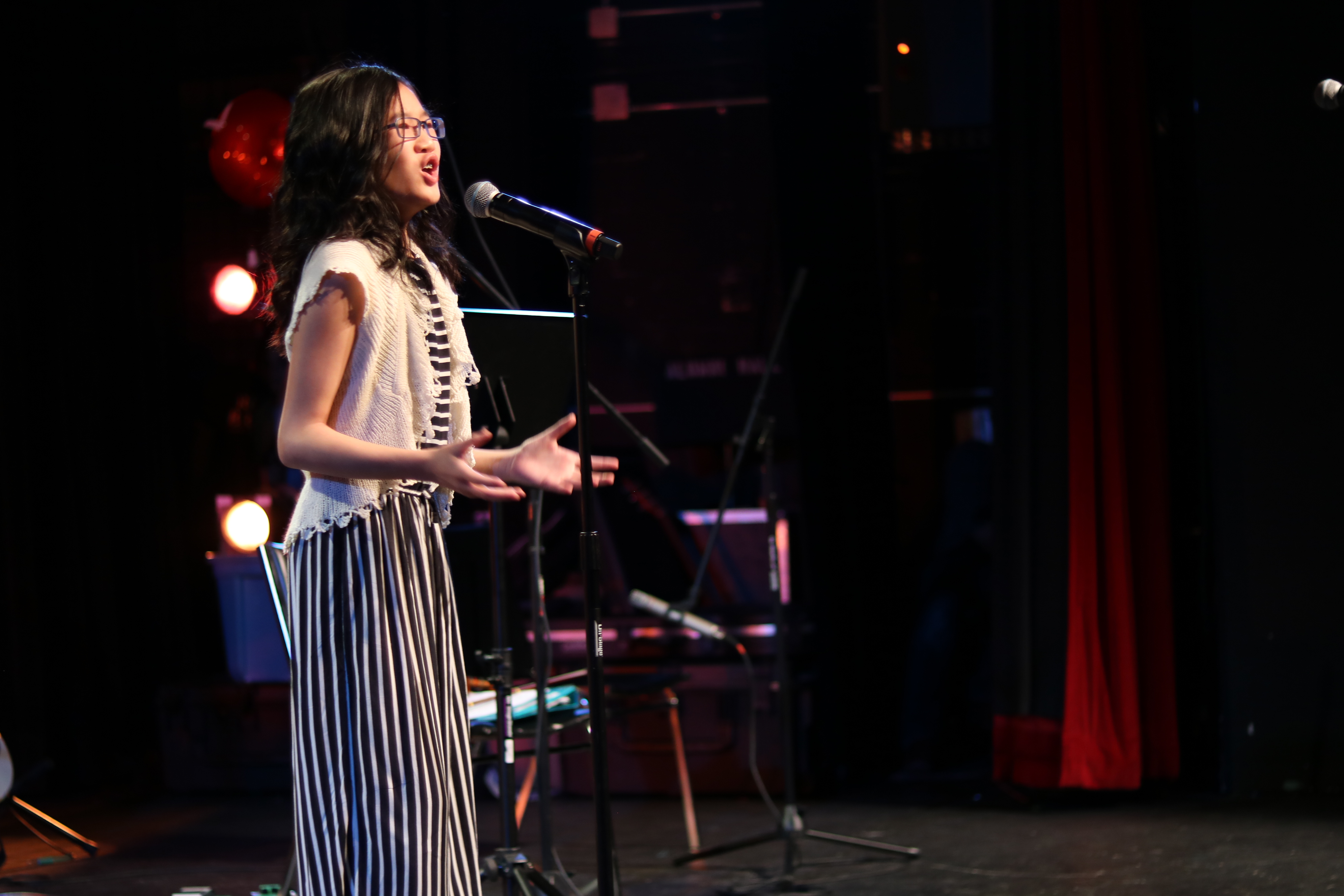 Live music performance venue at Real Brave Queens with guitar, piano, drum, vocal and band programs