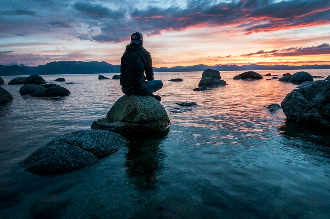 man meditating over Lake Tahoe