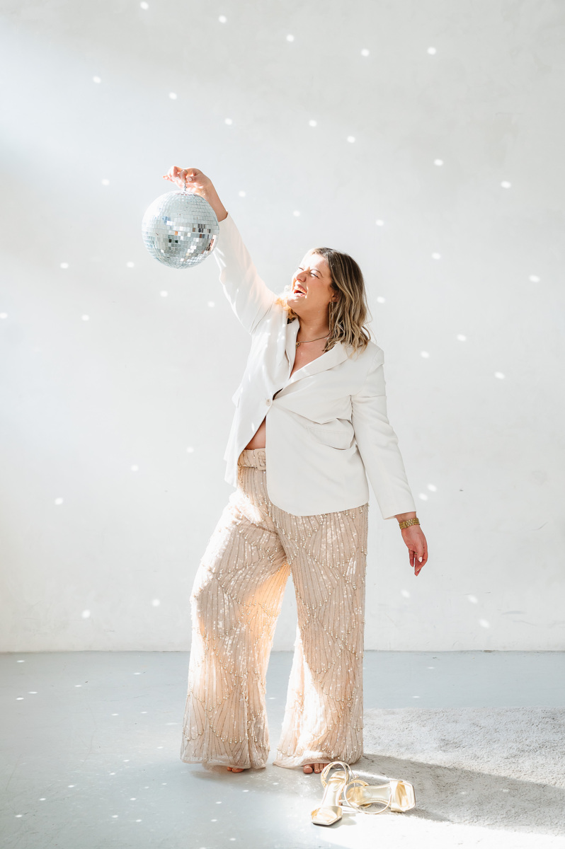 Elisabeth smiling while holding a disco ball, showcasing her dynamic approach as a London-based social media manager