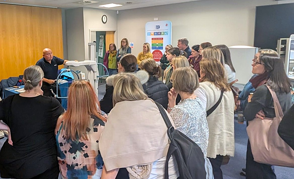 A supplier demonstrating to a group of gathered OTs