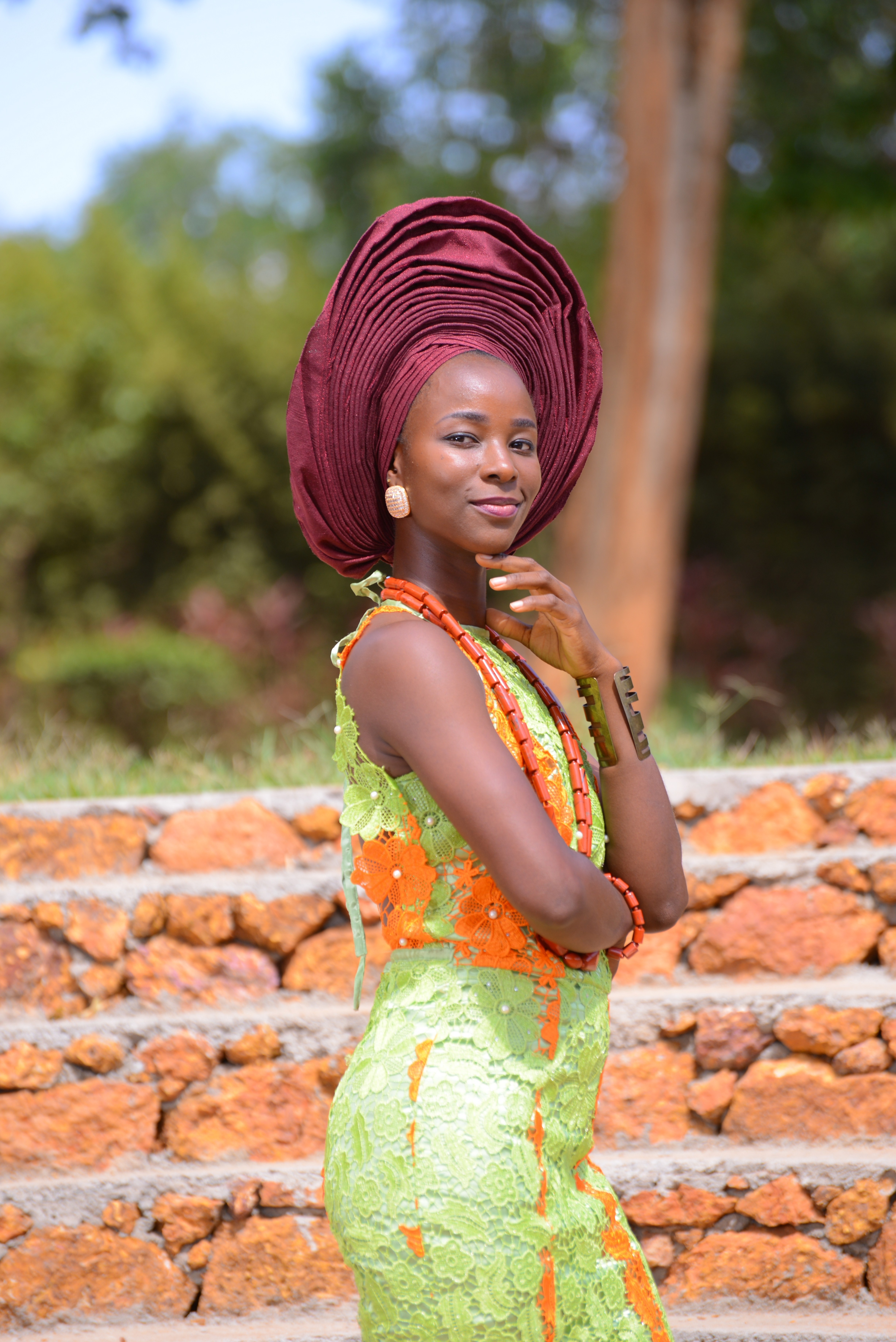 Portrait of Anu wearing beautiful traditional Yoruba attire, a regal gele, royal beads, lace mermaid dress, etc.