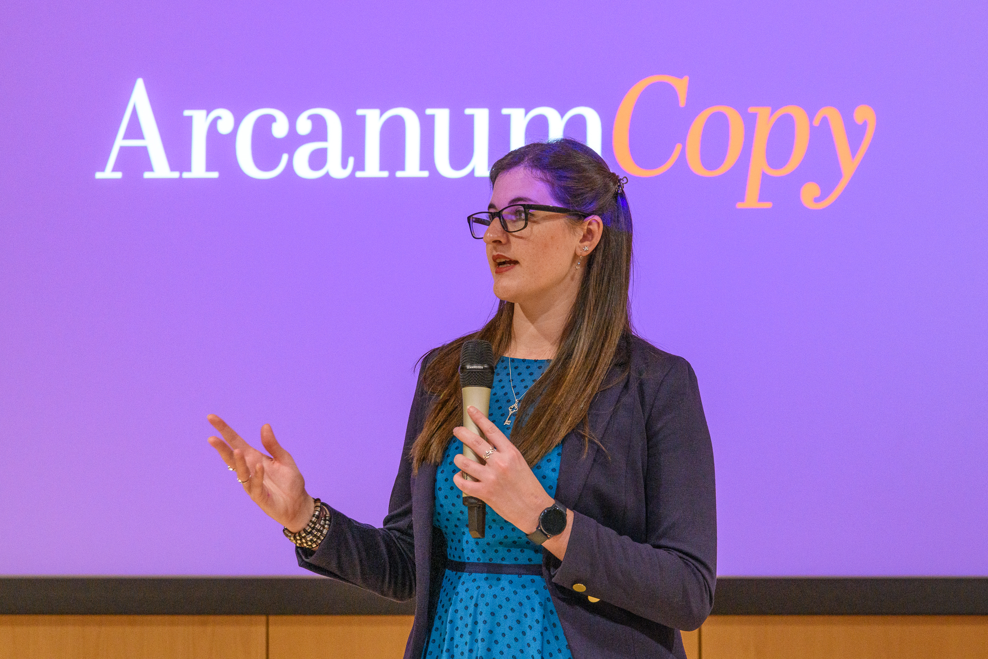 Eleanor Bryan delivering a presentation at a business conference.