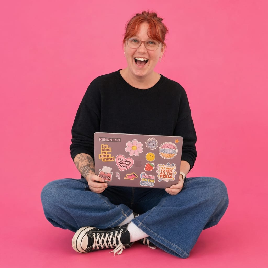 Wendy laughing with her sticker covered laptop